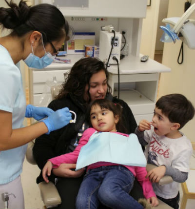 Two children in our kid friendly office getting dental care serving West Haven, Woodbridge, and Milford
