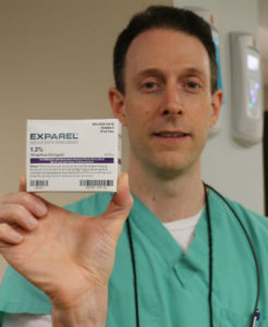 Dr. Nick Calcaterra, dentist in Orange, Connecticut, holding Exparel before performing wisdom teeth extraction surgery.