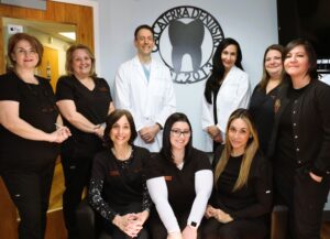 Orange, CT dental office team photo showing dentists Drs. Nick and Carla Calcaterra